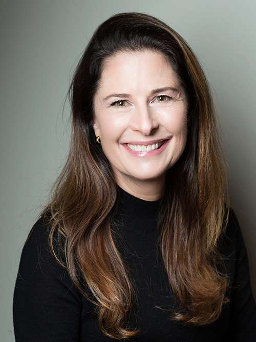 Linda Dean smiling in an indoor setting