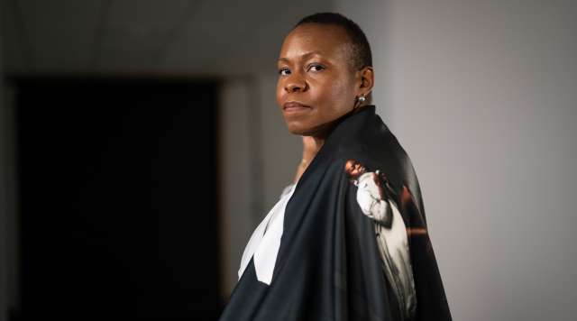 Woman wearing black cape