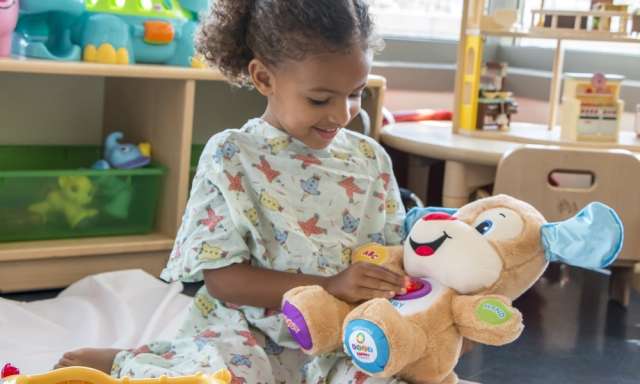 Child playing with stuffed animal