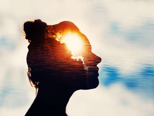 Silhouette of woman surrounded by water