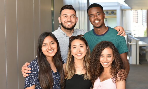 Group of diverse students smiling together during a UCLA Health outreach or pipeline program event.