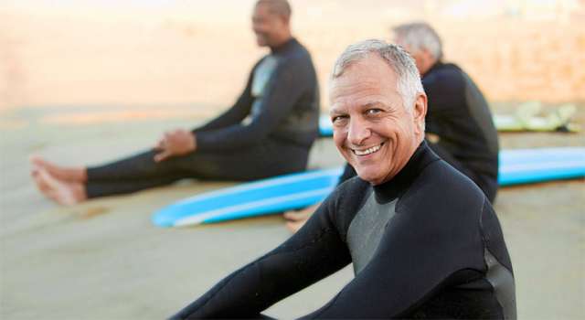 Older male surfer on beach