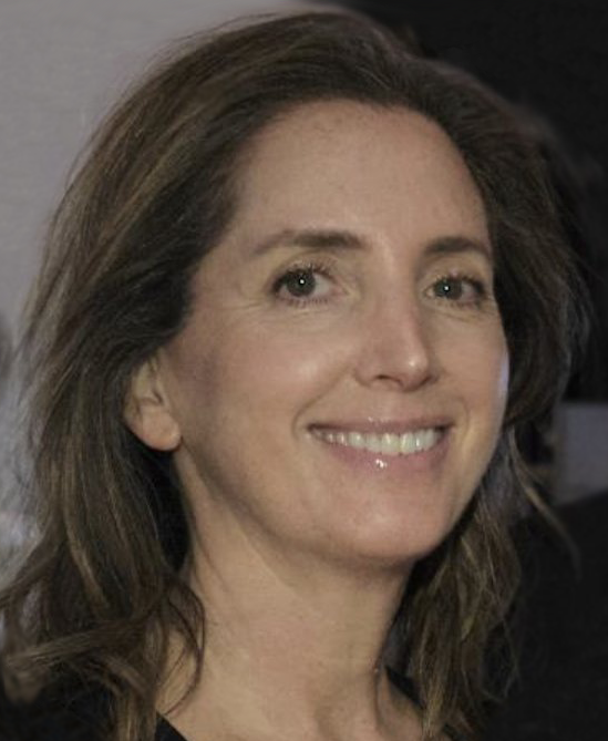Laura Schuman with shoulder-length brown hair, smiling