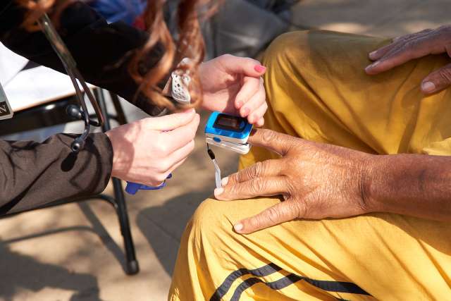 Doctor taking Oximeter reading
