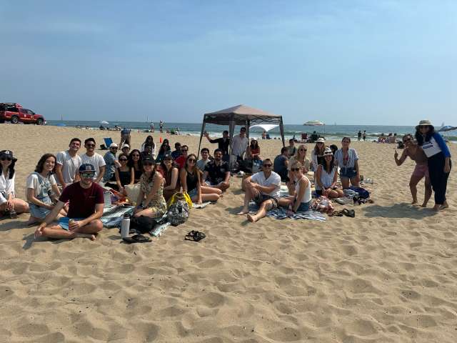 group of Internal Medicine Residents sitting together at the beach