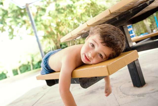 child laying on bench