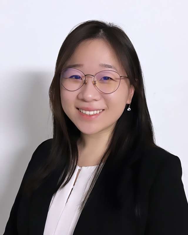  A headshot of Dr. Jenny Xinyu Ji, a young woman with long dark hair and glasses, smiling warmly against a white background.