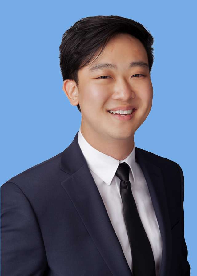 Headshot of Dr. Andrew Hong in black suit and tie