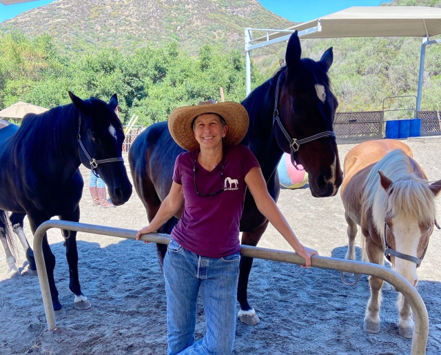 The image depicts a participant engaged in equine-assisted psychotherapy, a key component of UCLA Health's Operation Mend program. 