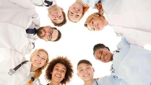 Diverse doctors forming a circle to demonstrate unity.