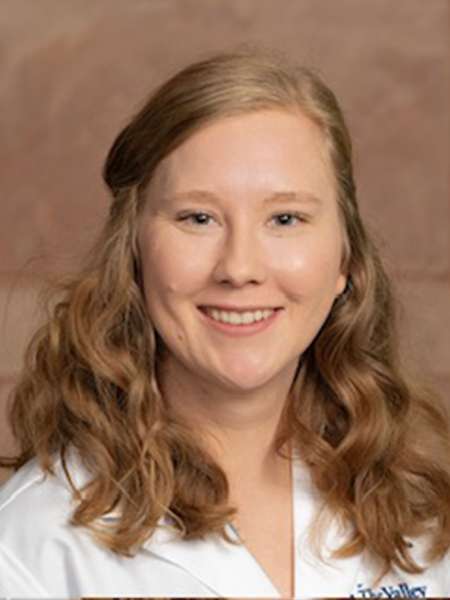 Dr. Gillian Mathews in a white lab coat