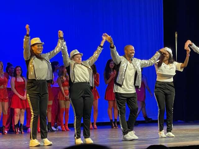 DAPM Mail Assistant, Kathy Good, taking a bow at dance performance with fellow dancers