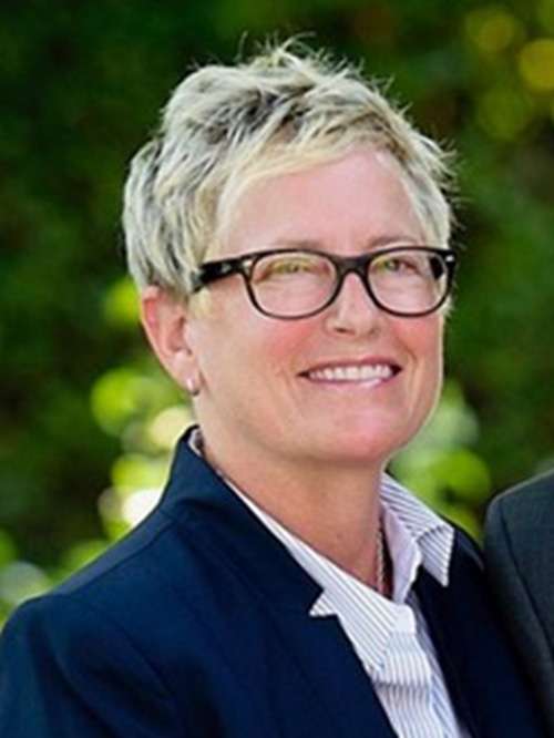 Lori Wolf smiling in an outdoor setting