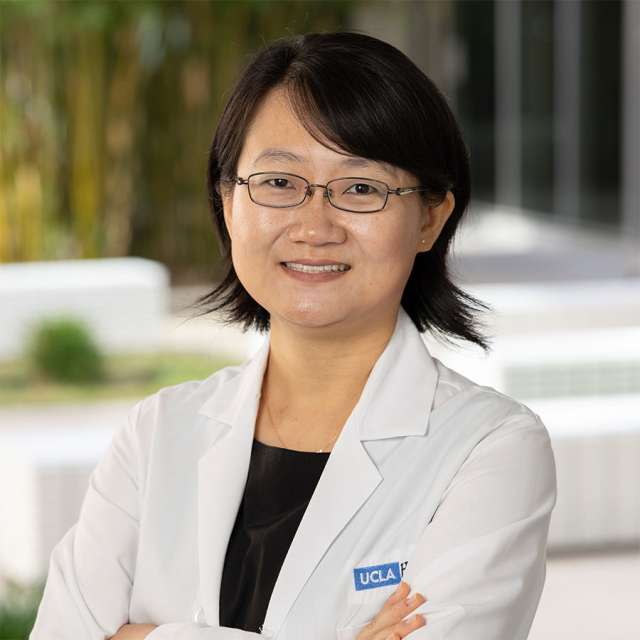 Dr. Esther Yu standing outside with a friendly smile.