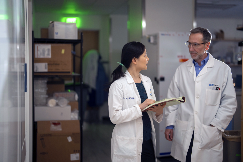 Dr. Antoni Ribas talking with another doctor in the hallway of a hospital