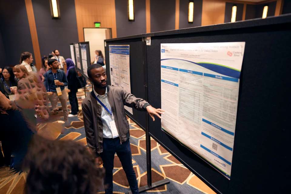 A UCLA young student presents his research poster