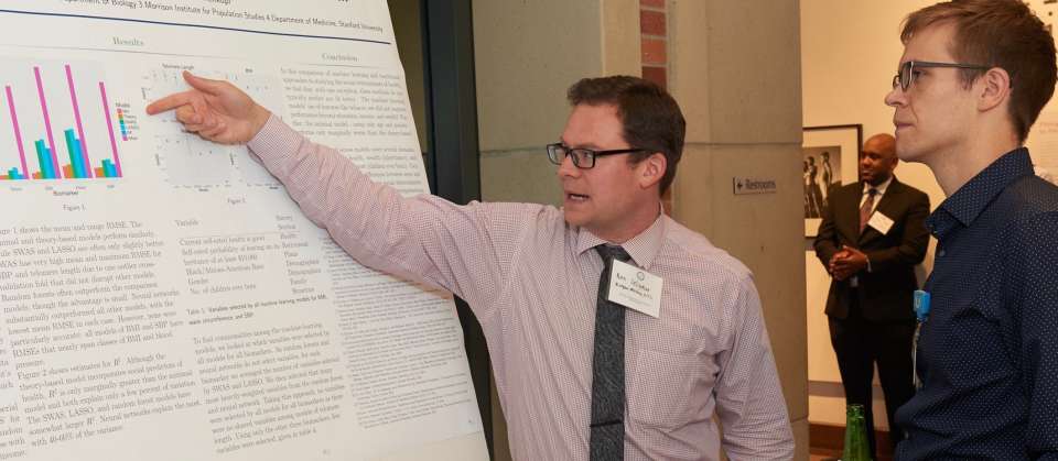 Man showing another man poster chart