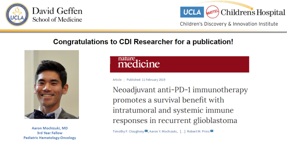 A male researcher in a suit and bow tie smiles next to a publication announcement from the David Geffen School of Medicine.
