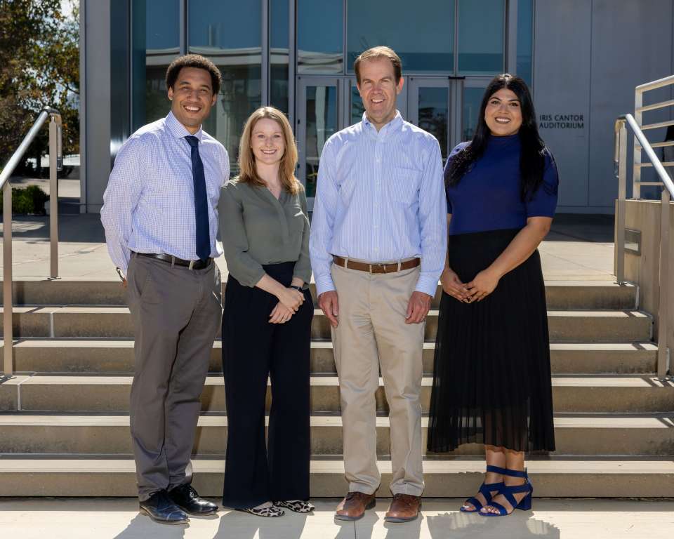 A group photo of the Laboratory Stewardship team on stairs in front of Geffen Hall