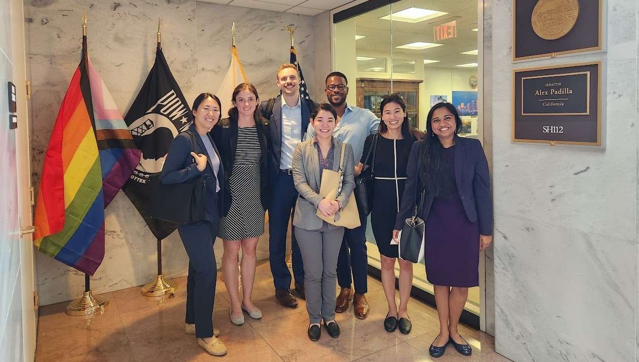 a group of people from the HSMP in a building with pride flags 