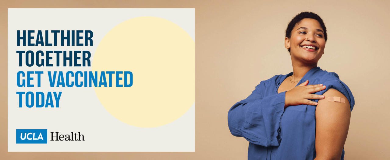 Smiling woman showing bandage on upper arm with 'Get vaccinated today' UCLA Health message