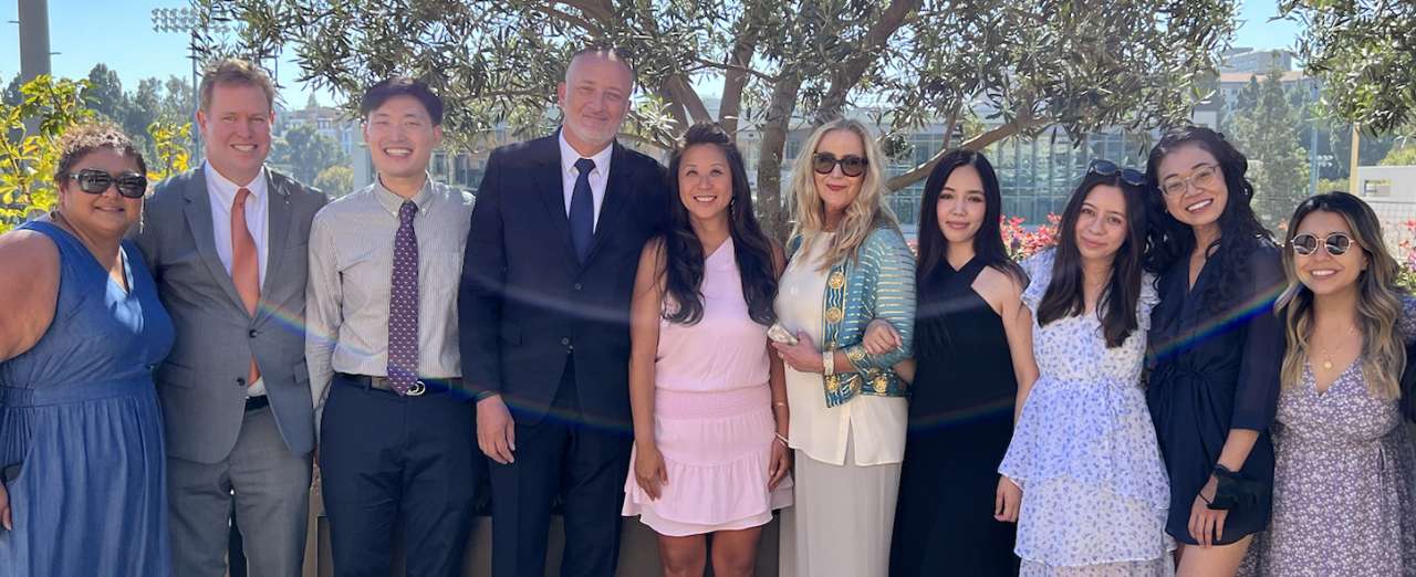 medical professionals at the Education Leadership retreat, smiling in an outdoor setting