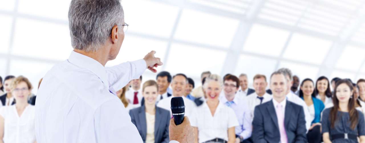 Speaker pointing into a crowd