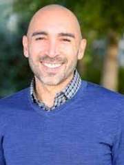 headshot of Marco Hidalgo in blue sweater