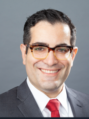 Headshot of Dr. Hugo Torres in gray suit