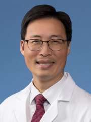 Michael W. Yeh, MD, in a white coat and tie.
