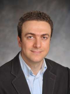 Cancer reseacher Dr. Aydogan Ozcan smiling and looking at the camera