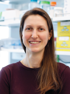 Dr. Kalli Kappel smiling in a laboratory.