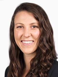 Headshot of Dr. Rachel Ohman, a woman with long wavy brown hair smiling directly at the camera.