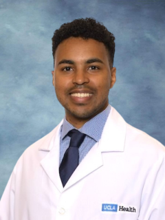 headshot of Dr. Ehab Bahrun wearing a lab coat in front of a blue background
