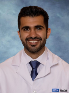 headshot of Dr. Edward Mezian in front of a blue background