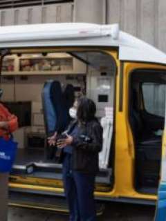 Dr. Briggs-Malonson and Holly Mitchell stand outside a UCLA Health Homeless Healthcare Collaborate van at the Care Harbor clinic