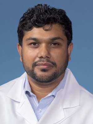 AHM (Zuberi) Ashraf, PhD in a white lab coat