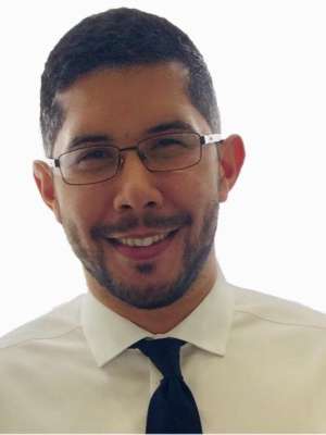 Headshot of a man in a dress shirt and tie