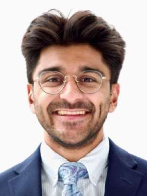 Druv Patel MD, smiling headshot in suit and tie