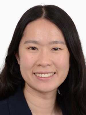 Smiling professional headshot of person with long dark hair