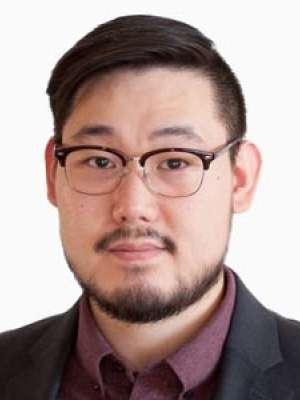 Timothy Kang headshot wearing glasses and a dark blazer