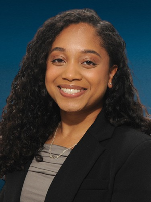 Head shot of Rehana Persaud in business attire smiling at the camera