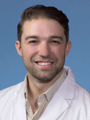 Cullen Lilley, MD, MS, MA in a white lab coat
