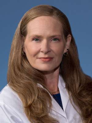 Rebecca Sosa, PhD in a white lab coat