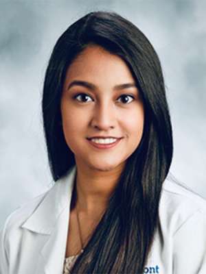 Doctor Khandaker in a white coat with a light grey background