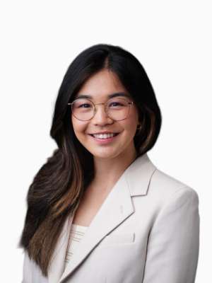 Sandra Kong smiling headshot with glasses and a light blazer