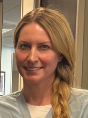 Amarra Mchale, FNP smiling in scrubs.