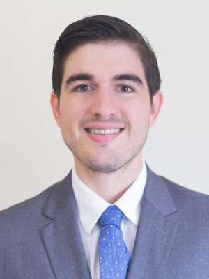 Marcos Estrada Rodriguez, MD headshot, wearing a suit and tie