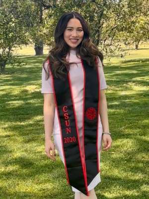 Arlyn, who has brown hair, wearing a class of 2020 CSUN graduation stole
