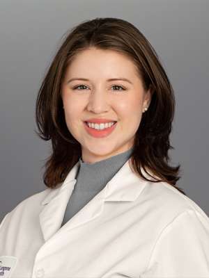 Dr. Monika Schmitt in a white lab coat